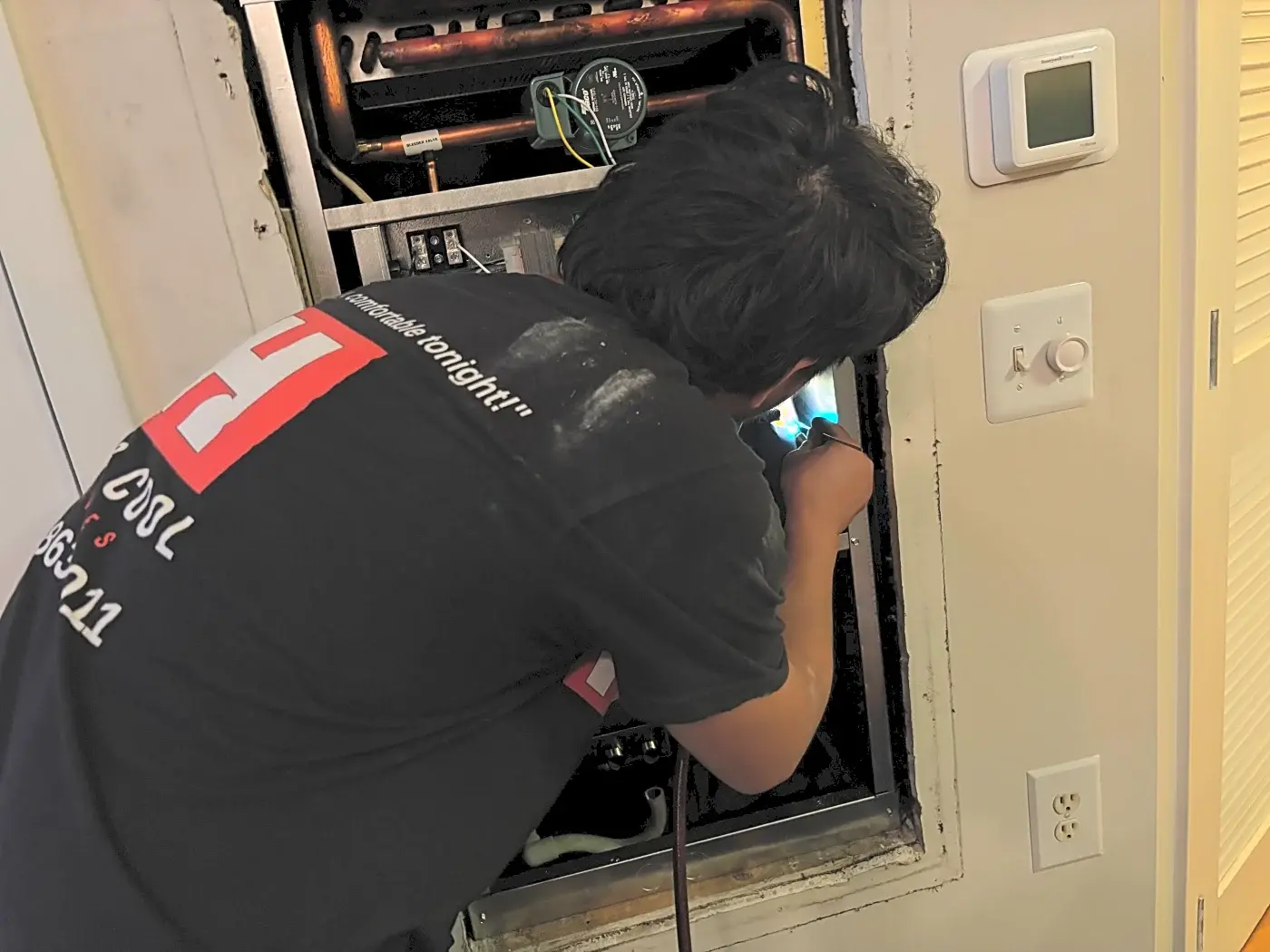 Hot & Cool Services technician soldering an HVAC system connection